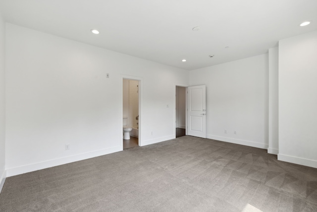 unfurnished bedroom featuring carpet floors and connected bathroom