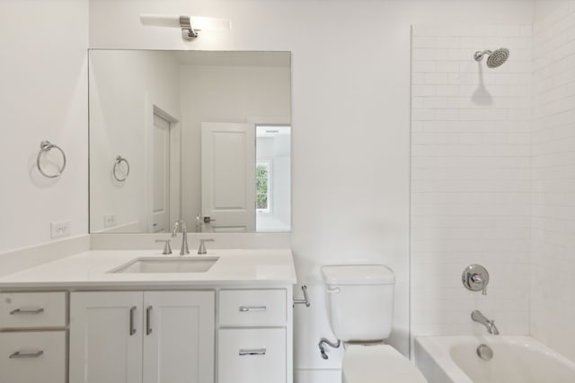 full bathroom featuring vanity, tiled shower / bath combo, and toilet