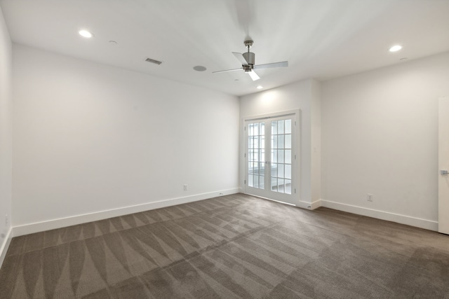 carpeted spare room with ceiling fan and french doors