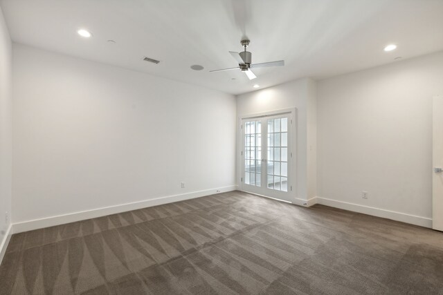 spare room featuring recessed lighting, baseboards, and dark carpet