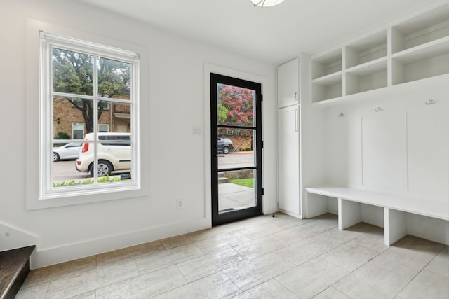 mudroom with light tile patterned flooring and a wealth of natural light