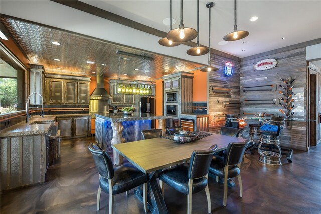 dining room featuring sink and wooden walls