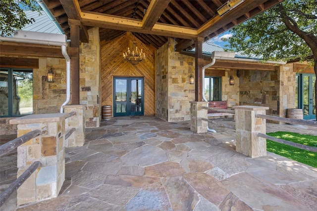 entrance to property featuring french doors and a patio area