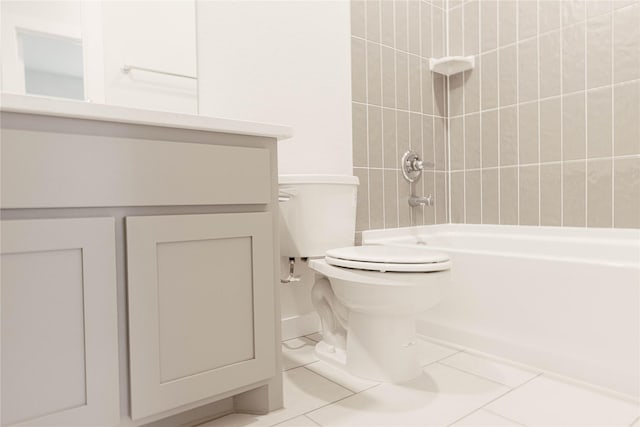 full bathroom featuring toilet, vanity, tiled shower / bath, and tile patterned flooring