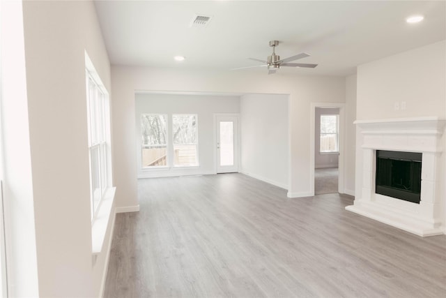 unfurnished living room featuring light wood-type flooring and ceiling fan