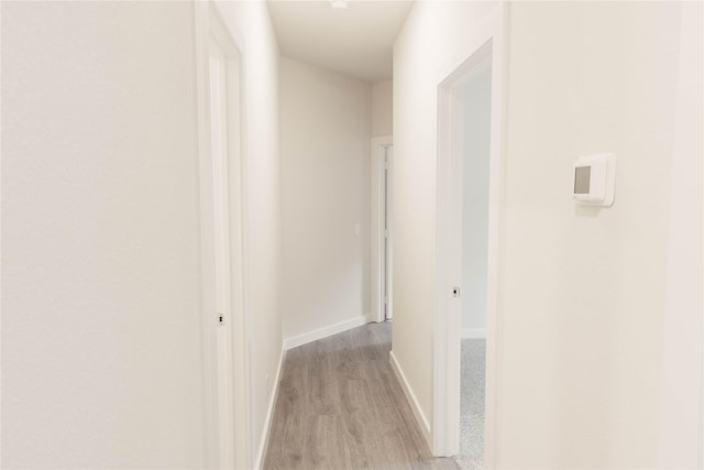 corridor with light wood-type flooring