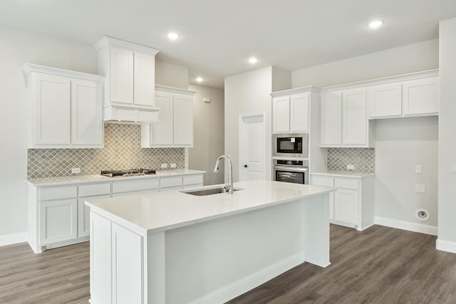 kitchen with stainless steel appliances, dark brown cabinetry, light stone counters, and tasteful backsplash