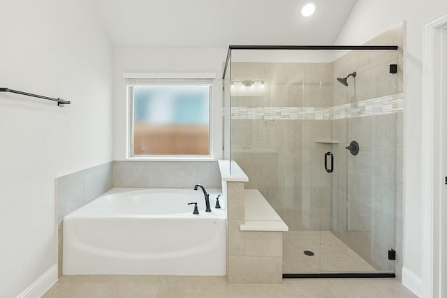 bathroom featuring plus walk in shower, tile patterned flooring, and vaulted ceiling