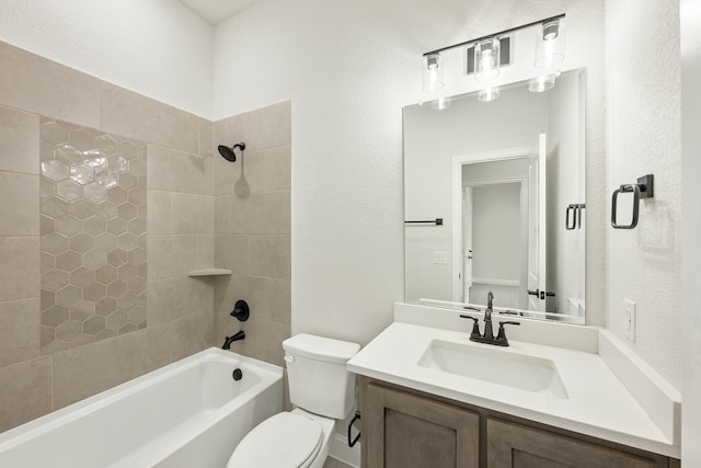 full bathroom with toilet, tiled shower / bath, and vanity