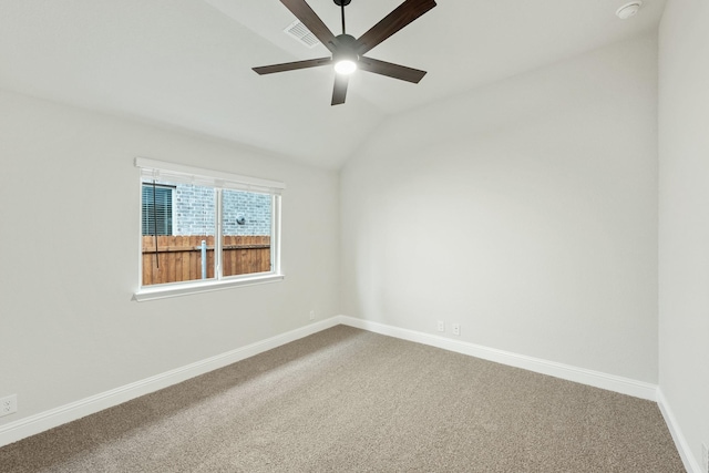 spare room featuring ceiling fan, carpet floors, and lofted ceiling