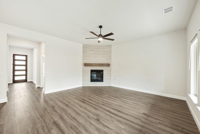 kitchen featuring stainless steel gas stovetop, vaulted ceiling, sink, light stone counters, and an island with sink