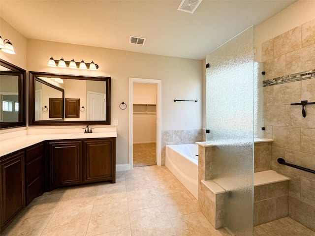 bathroom with vanity, tile patterned floors, and shower with separate bathtub