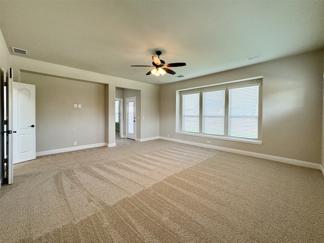 spare room with ceiling fan, light colored carpet, and a textured ceiling