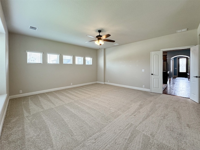 carpeted empty room featuring ceiling fan