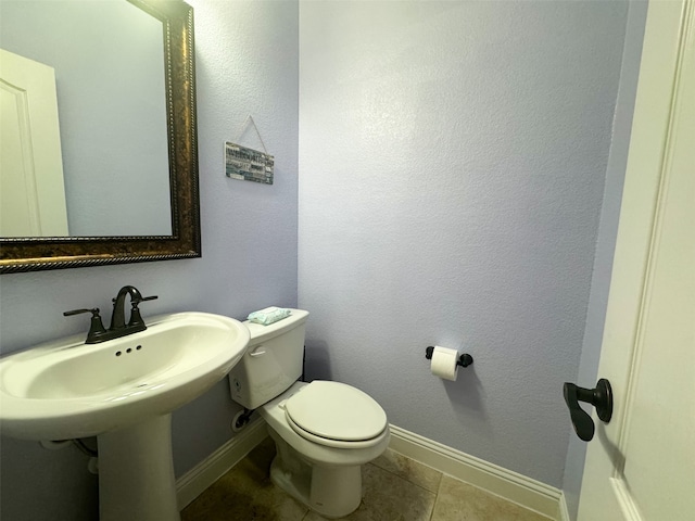 bathroom with tile patterned flooring and toilet