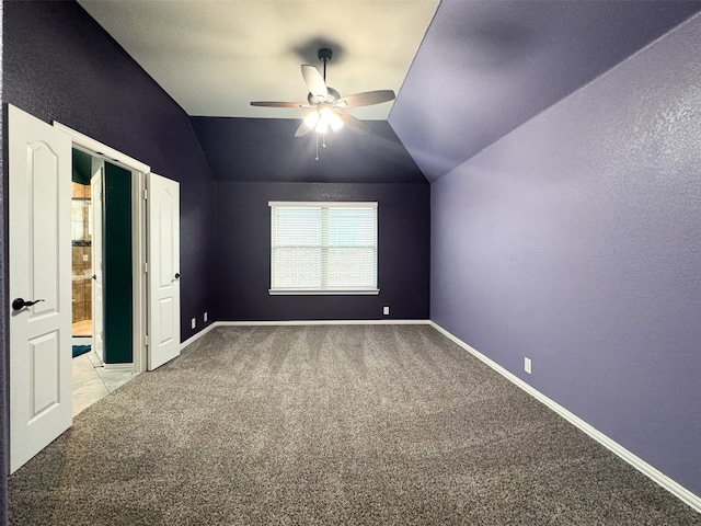 empty room with light carpet, lofted ceiling, and ceiling fan