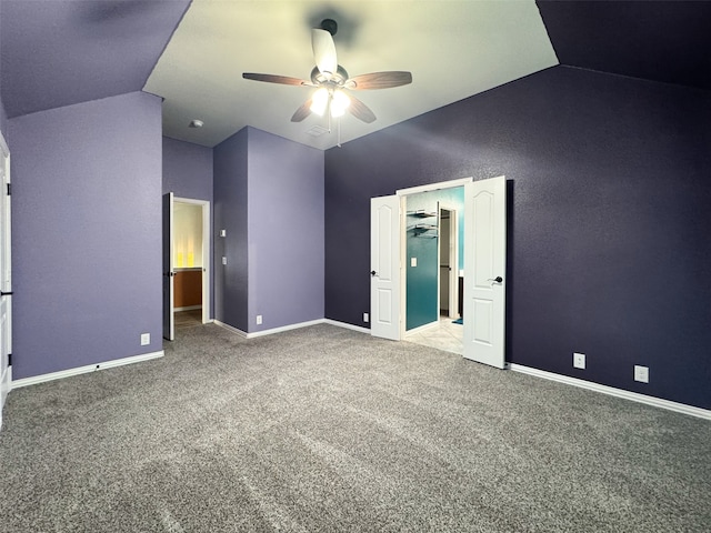 carpeted spare room with lofted ceiling and ceiling fan