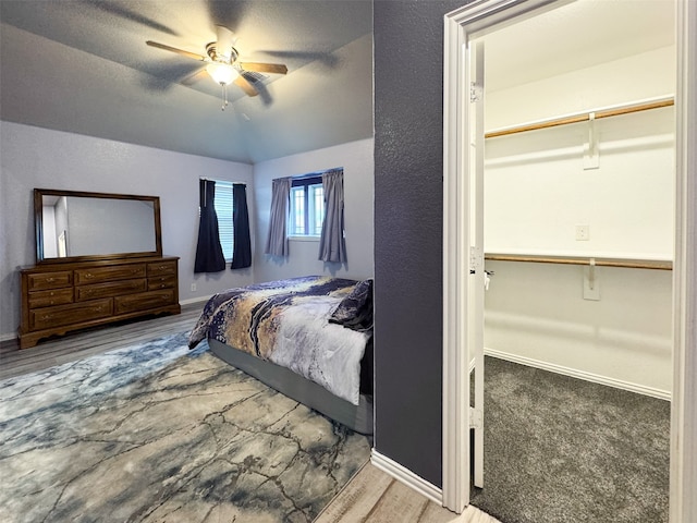 bedroom with a closet, ceiling fan, carpet floors, and a textured ceiling