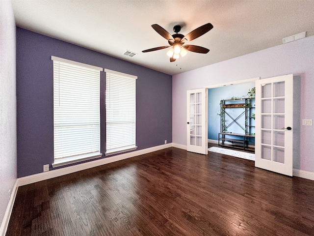 empty room with french doors, a textured ceiling, ceiling fan, and dark hardwood / wood-style floors