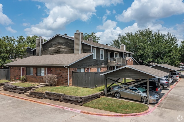 view of front of home with a carport and a balcony