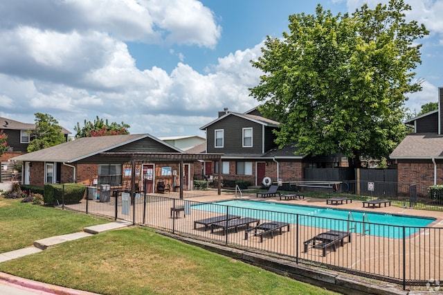 view of pool featuring a yard and a patio area