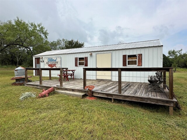 exterior space with a deck and a front yard