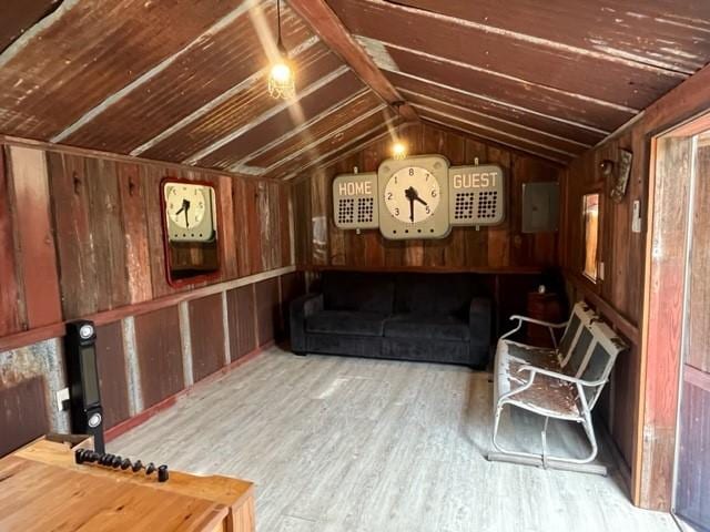 interior space featuring wood ceiling, vaulted ceiling, wooden walls, and wood finished floors