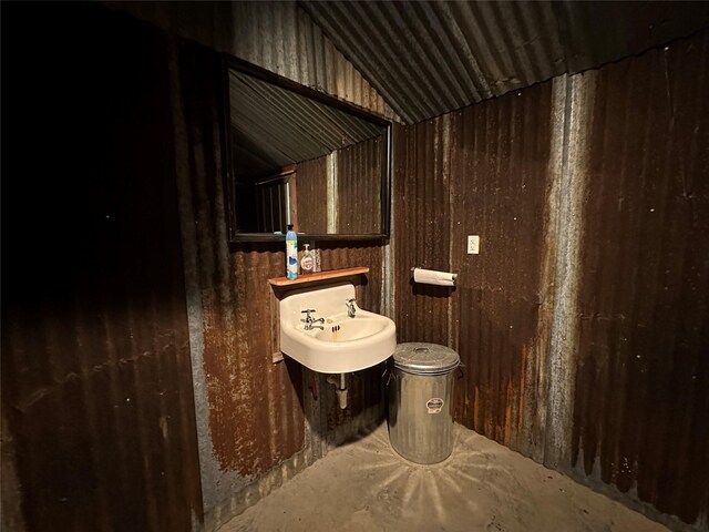 bathroom featuring sink, toilet, and lofted ceiling