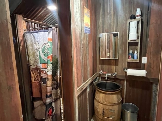 bathroom with sink and wood walls