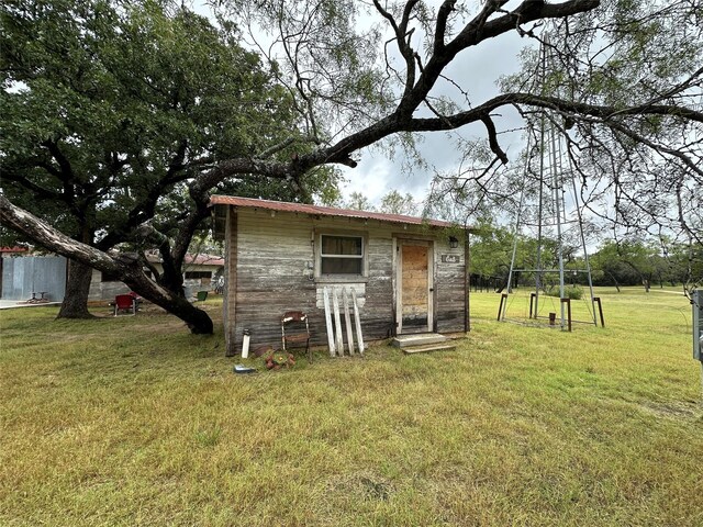 view of outbuilding featuring a yard