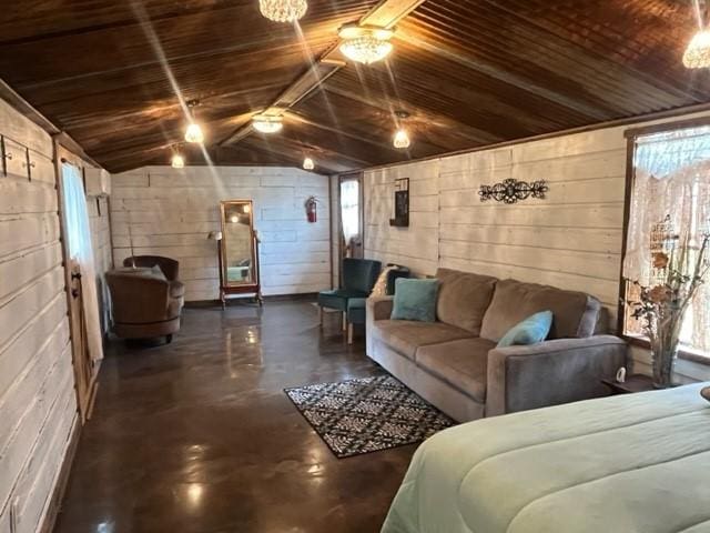living room featuring wood ceiling, concrete block wall, lofted ceiling, and finished concrete flooring