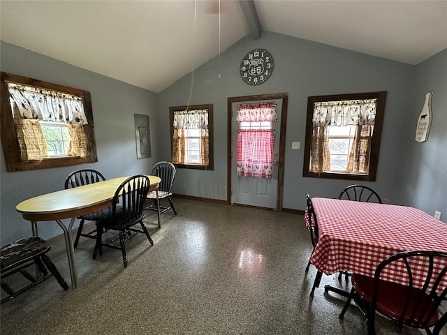 dining room featuring lofted ceiling with beams