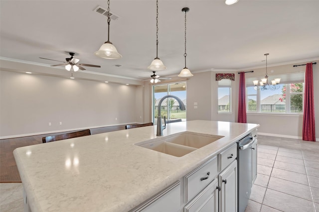 kitchen with sink, white cabinetry, light stone counters, stainless steel dishwasher, and an island with sink