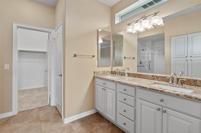 bathroom with an enclosed shower, vanity, and tile patterned floors