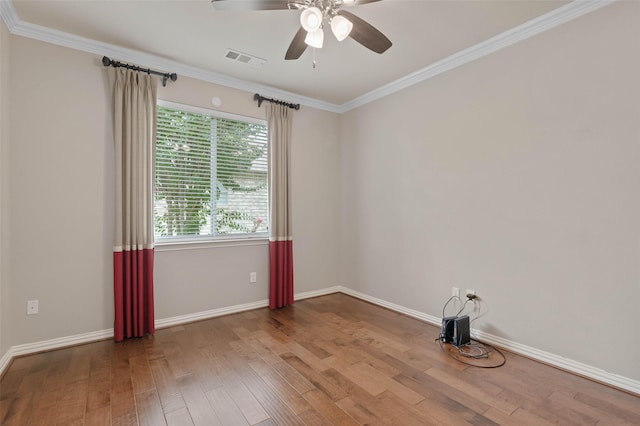 empty room with hardwood / wood-style floors, crown molding, and ceiling fan