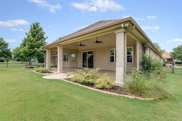 back of house with a lawn, a patio, and ceiling fan