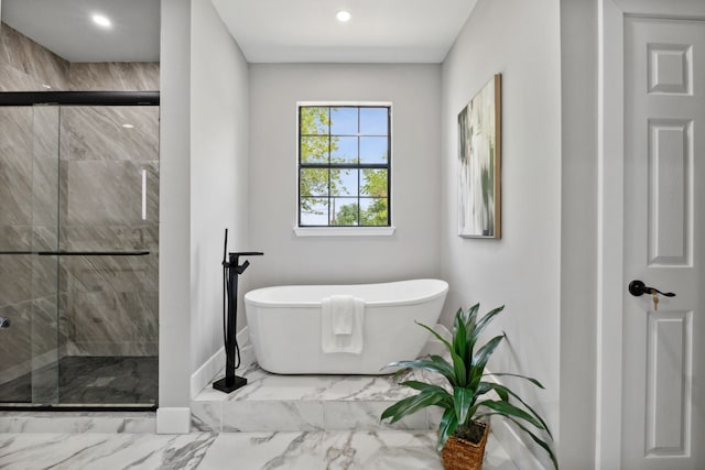 bathroom with a freestanding tub, a shower stall, marble finish floor, and recessed lighting