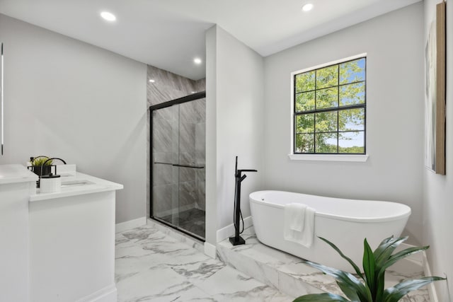 bathroom with recessed lighting, baseboards, marble finish floor, a soaking tub, and a shower stall