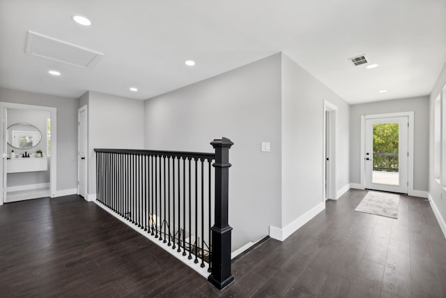 foyer entrance with dark wood-type flooring, recessed lighting, visible vents, and baseboards