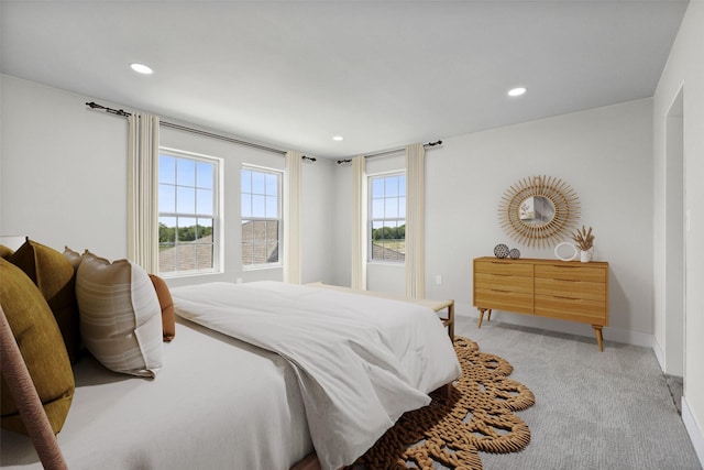 bedroom featuring light carpet, baseboards, and recessed lighting