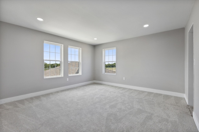 empty room featuring recessed lighting, carpet flooring, and baseboards