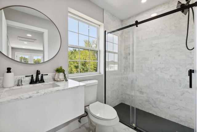 bathroom with toilet, marble finish floor, a wealth of natural light, and a stall shower