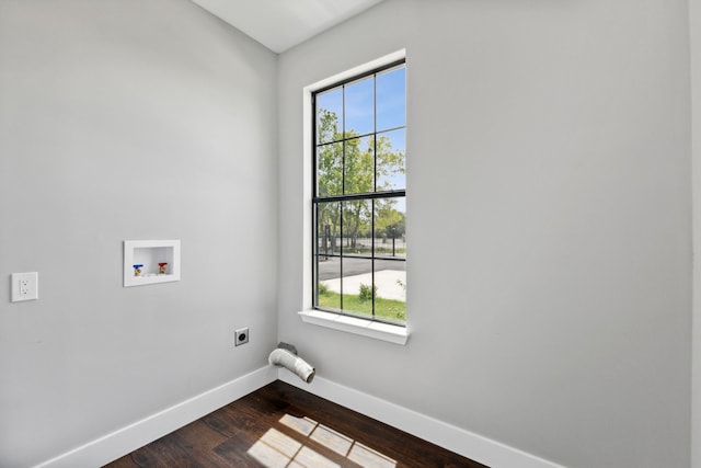 laundry area featuring dark wood-style flooring, hookup for a washing machine, electric dryer hookup, laundry area, and baseboards