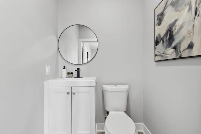 bathroom featuring toilet and vanity