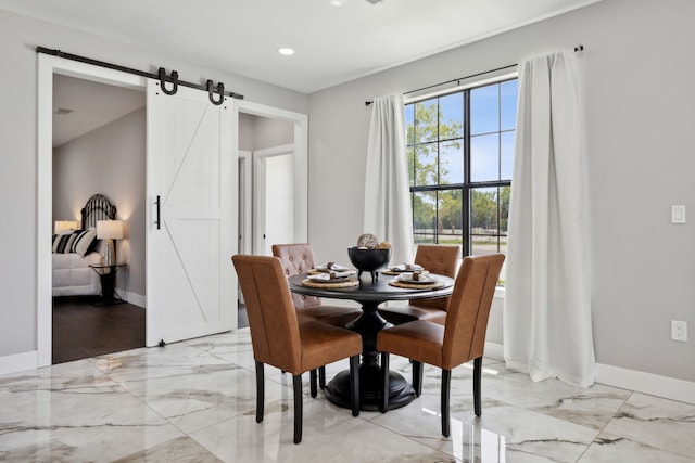 dining area with marble finish floor, a barn door, baseboards, and recessed lighting