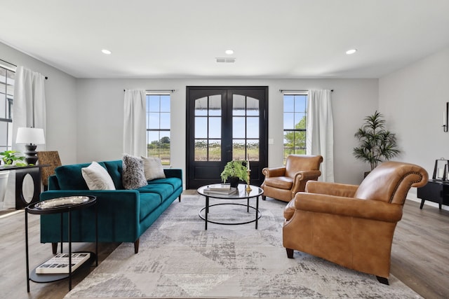 living room with light hardwood / wood-style floors and french doors