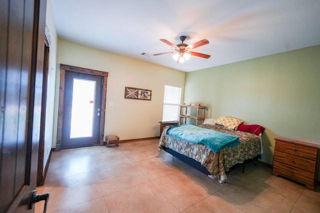 tiled bedroom featuring ceiling fan