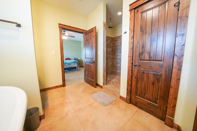 bathroom featuring tiled shower and tile patterned floors