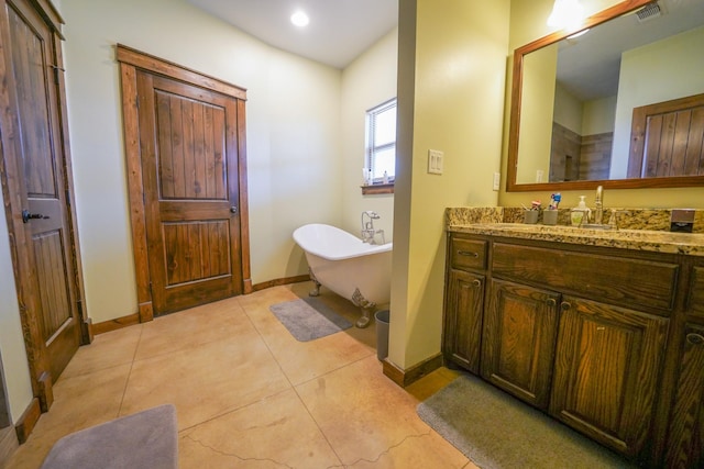 bathroom with vanity, tile patterned floors, and a bathtub