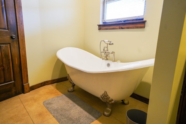 bathroom with tile patterned flooring and a tub to relax in